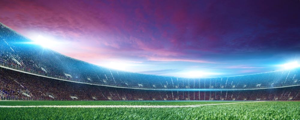 Football stadium with clouds overhead at dusk