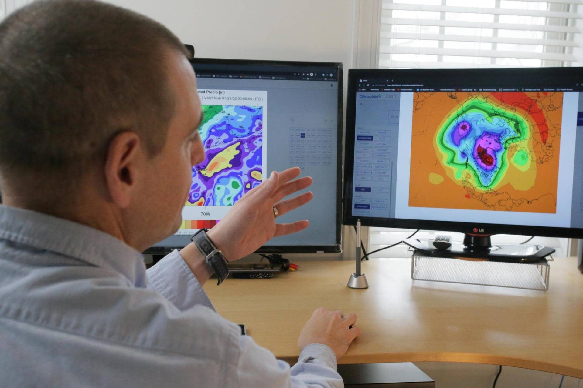 Engineer explaining something on monitors