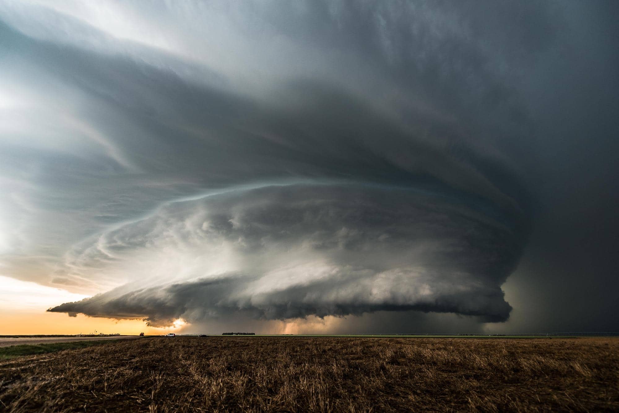 Large storm clouds hovering over an open field